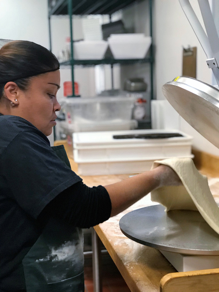Female worker making a tortilla