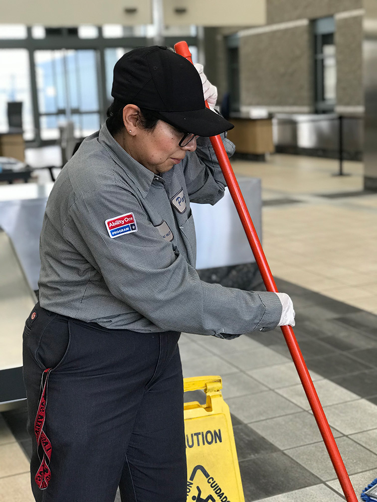 Female janitor cleaning the floor